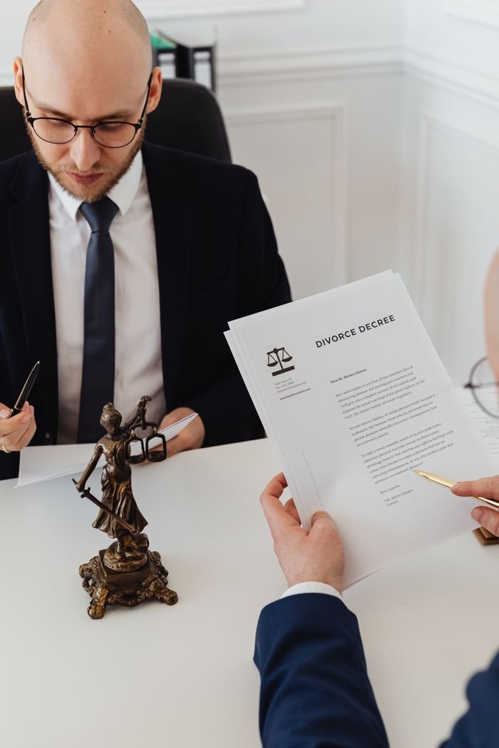 Mastering the First Impression: Your intriguing post title goes here Two lawyers discussing divorce decree documents in a professional office setting.