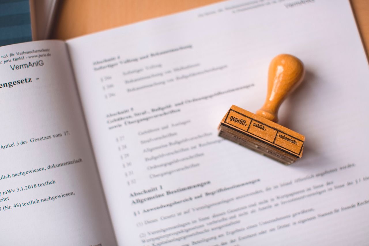 About Close-up of a legal document with a wooden stamp placed on top, highlighting verification.